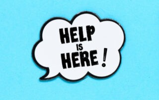 light blue background with a white speech bubble in the center with text inside that reads help is here!