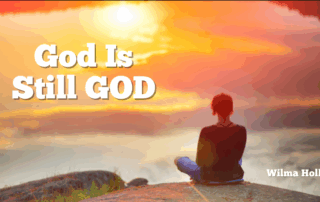 Woman staring into the sunset over the mountains God is Still God